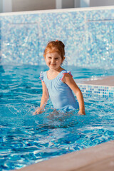 Fototapeta na wymiar Little girl having fun in swimming pool.