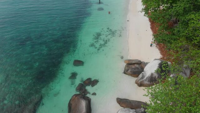Top down shot of beach with turquoise coloured water at belitung Indonesia, aerial