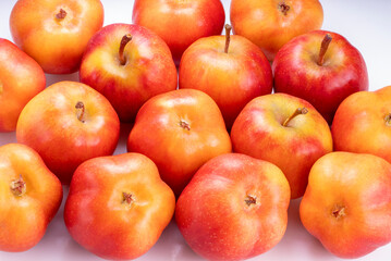 Tiny Red star apple in Bamboo basket on  table, Korea Star Apple with on white background.
