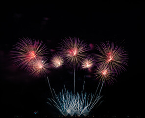 Fototapeta premium Fireworks show under defocus or blur concepts with isolated black background at night, this celebration is for the International Fireworks Festival in Pattaya on Nov 24-25 in Thailand