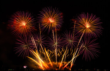 Fireworks show under defocus or blur concepts with isolated black background at night, this celebration is for the International Fireworks Festival in Pattaya on Nov 24-25 in Thailand