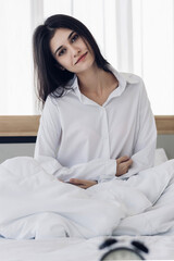 Woman stretching in bed after wake up. stretching and happy woman waking up in the morning after sleep, rest and relax at home.