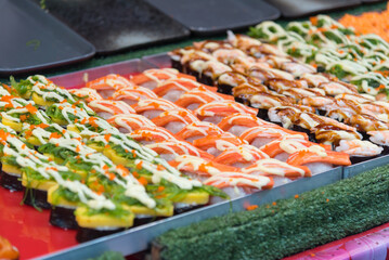 Closeup focus to row of sushi menu  in the tray