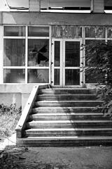 Stairs to the Old run-down gas station with gas pumps as a lost place in Wallachia in Romania in...