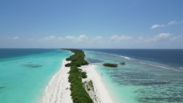 Aerial above Long lush sanbar amid vast blue lagoon on Dhigurah island, Maldives