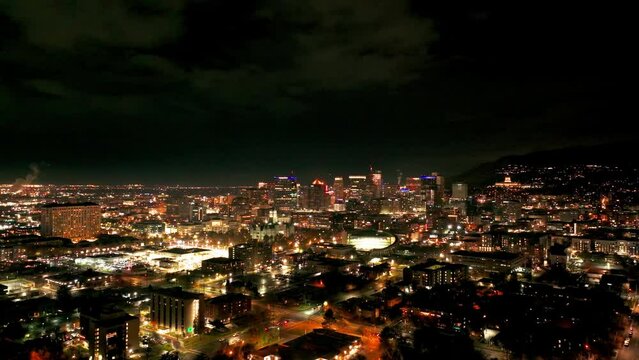 Wide angle drone view panning to the left of downtown Salt Lake City at night