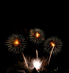 Fototapeta premium Fireworks show under defocus or blur concepts with isolated black background at night, this celebration is for the International Fireworks Festival in Pattaya on Nov 24-25 in Thailand