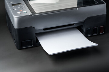 Modern laser printer on black background close up