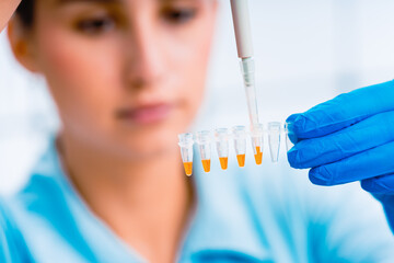 Scientist holding test tube in laboratory conducting scientific experiment