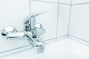 Clean bathroom sink with metal faucet and sanitary tap.