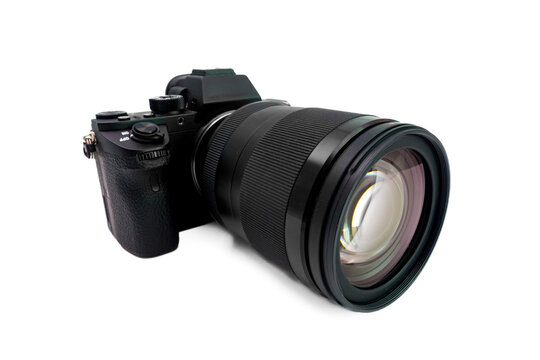 Close-up of a black camera lens on a white background.