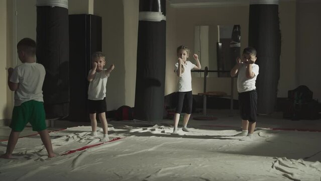 Children in fighter positions in martial arts class