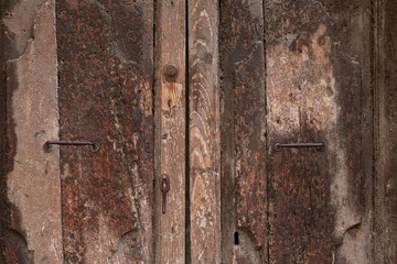 Abstract detail of an aged, rotting, wooden door in Tuscany, Italy