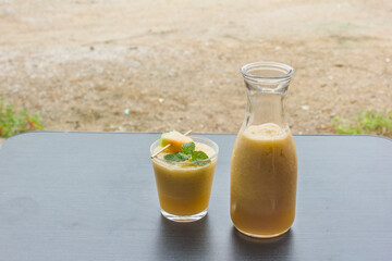 The juice of melon with mint in a glass jar on the table.