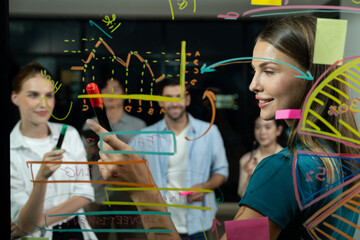 Group of smart diverse businesspeople brainstorming business strategy. Young female leader sharing, explaining, designing business idea at night office. Business planing, Working together. Tracery.