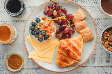 Breakfast: croissants, yogurt, fruit and coffee.