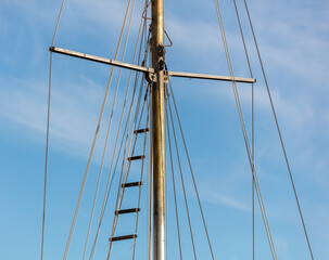 Mast on a ship against the blue sky