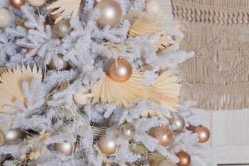Close up of beautiful white fir branches with shiny golden, silver and white baubles or balls, shiny ornaments and garland lights, home Decoration.Festive new 2024 year