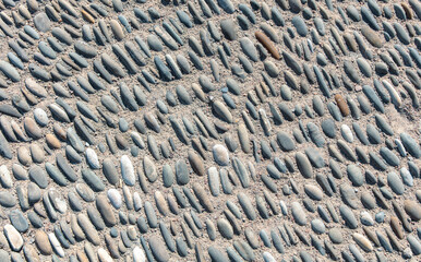 Pebble road as an abstract background. Texture