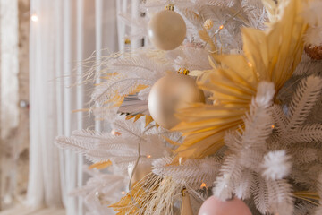 Close up of beautiful white fir branches with shiny golden, silver and white baubles or balls, shiny ornaments and garland lights, home Decoration.Festive new 2024 year