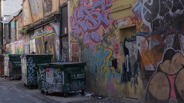 Waste Containers And Walls In The Alley Covered In Graffiti In Vancouver, Canada. - handheld shot