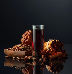 Coffee liquor with ingredients on the black reflective background.