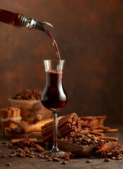 Coffee liquor is poured from a bottle into a glass.
