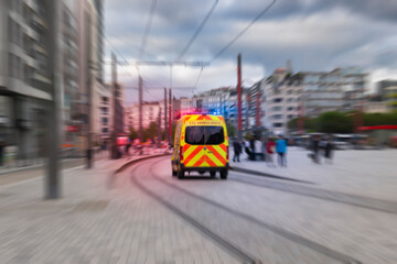 Blurred back view of emergency ambulance car in the street. - obrazy, fototapety, plakaty