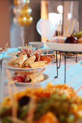 Snacks for the holiday, catering. Various light snacks. Food for a buffet table in a restaurant. Assortment of sandwiches on the buffet table.
