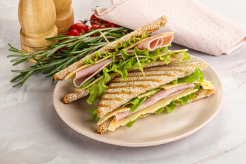Homemade club sandwich with ham and cheese