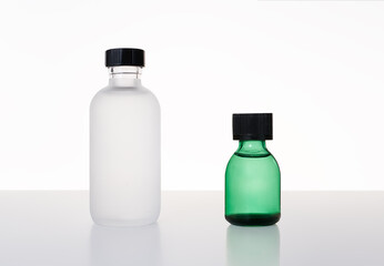 Glass bottles for cosmetic products with white background