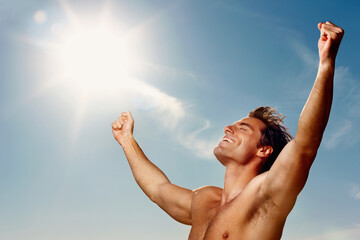 Freedom, hands raised and a shirtless man on a blue sky with flare for fresh air in summer during...