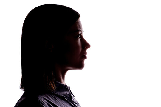 Dark silhouette of a young woman on white background side view.