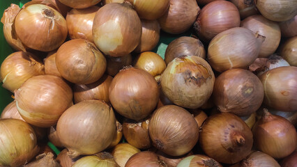 A pile of onion is being displayed in the market 