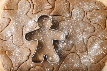 Cooking ginger cookies, Christmas and New Year traditional cookies in shape of gingerbread man, raw...