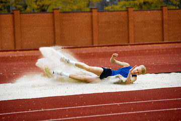 Energetic long jump showcased in a captivating frame. Portrait of athletic young man have long...