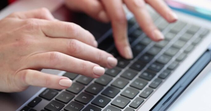 Female hands typing on laptop keyboard closeup 4k movie slow motion. Online work concept