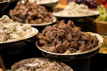 A bounty of grilled meats and dressed salads, a rustic culinary spread. This traditional dining...