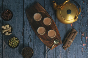 Fresh milk masala tea or Indian Kadak Chai.  Herbal tea in glass cups. Locally called mini cutting...