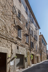 old houses in narrow street, Volterra, Italy