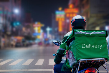 At Street Food in night city, Thailand, delivery drivers are making deliveries to consumers who...