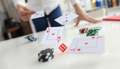 Poker player throws ace cards and casino chips. Gambling poker and financial earnings