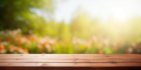 Empty wooden brown table in beautiful blurred spring landscape, wood plank board with green grass and flowers . Beauty bokeh and sunlight.,horizontal background or wallpaper, copy space