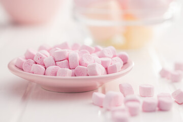 Mini sweet marshmallows candy on plate.