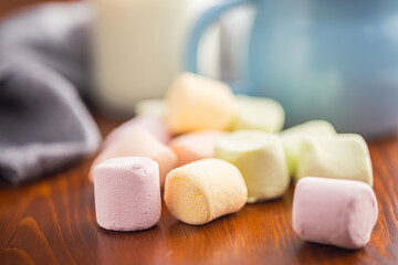 Sweet marshmallows candy on kitchen table.