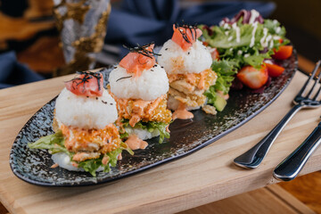 Sushi Burger, sandwich or slider served on wooden board isolated on table top view of arabic fastfood