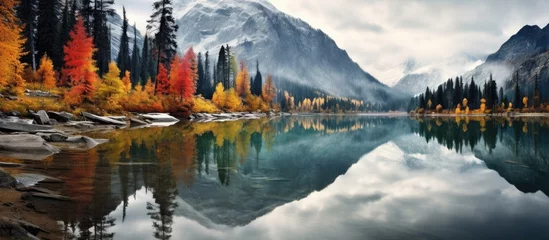 Foto op Plexiglas Autumn landscape reflected in Canadian mountain lake. © AkuAku