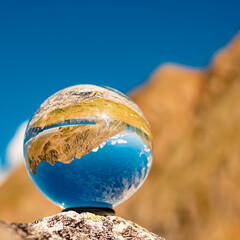 Crystal ball alpine summer landscape shot near Dresdnerhuette, Mutterbergalm, Stubaital valley, Innsbruck, Tyrol, Austria