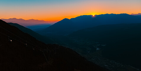 Fototapeta premium Alpine summer sunrise with Mount Patscherkofel in the distance at Mount Kreuzjoch, Fulpmes, Stubaital valley, Innsbruck, Austria