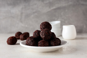 Brigadeiro on plate on gray background, close up